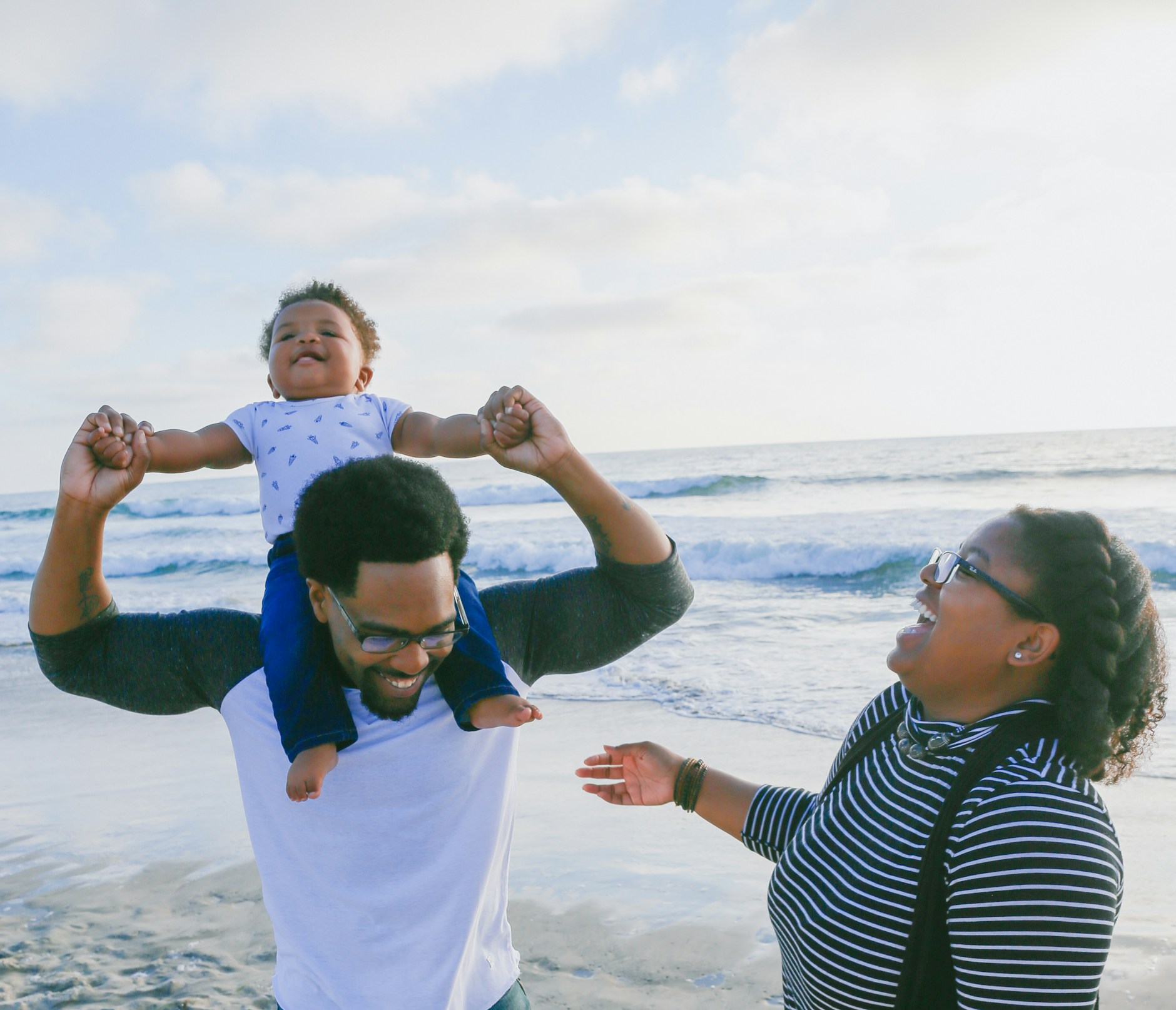 A father carrying his son on his shoulders at the beach