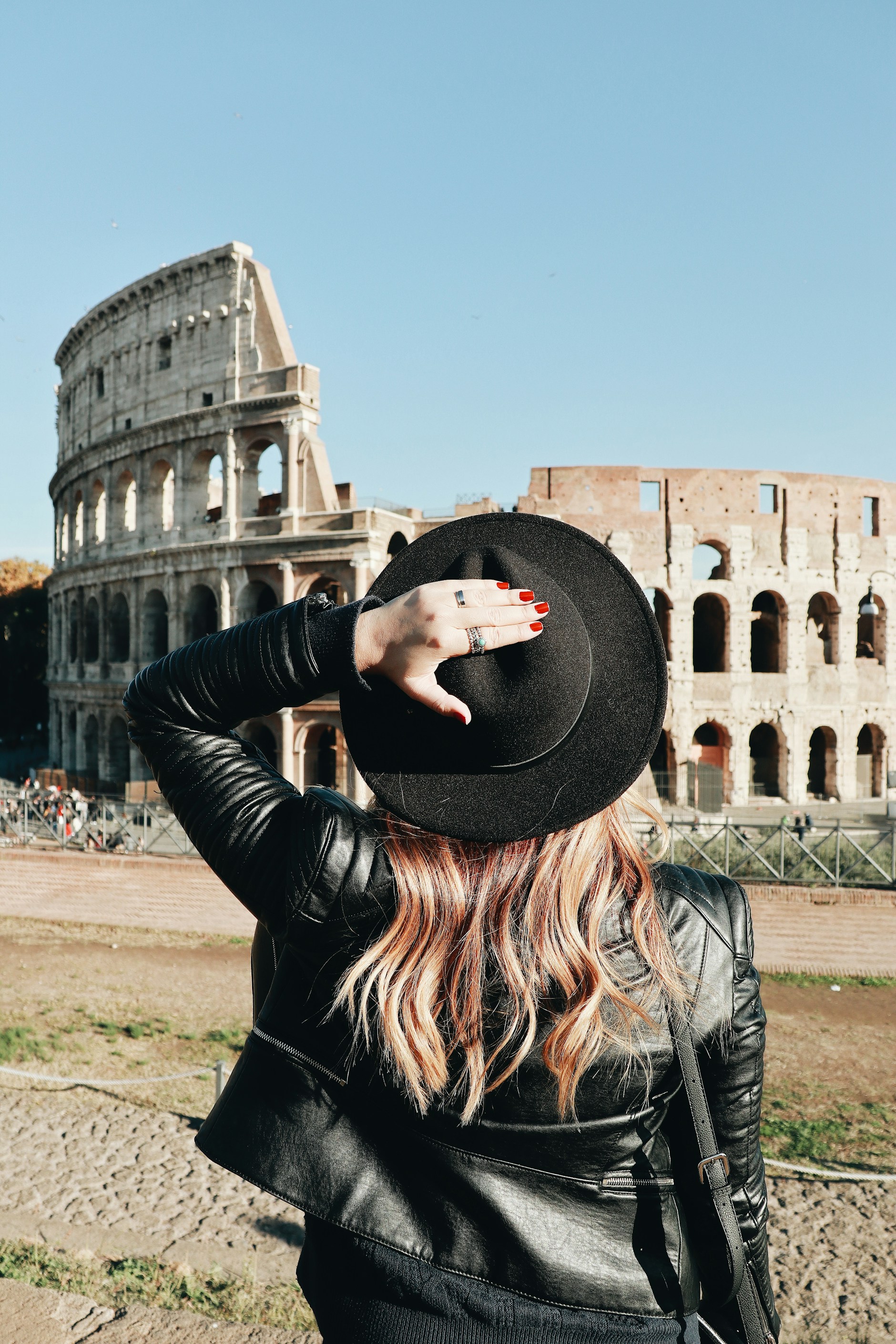 A traveler looking out at the Colosseum in Rome